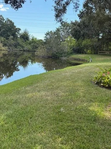 a view of a fountain in middle of the green field