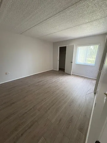a bathroom with a granite countertop sink toilet and a mirror