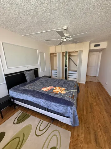 a bedroom with a bed and wooden floor