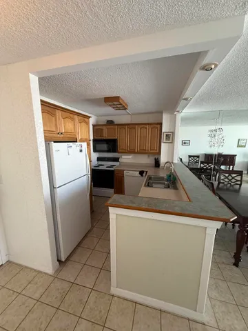 a kitchen that has a sink and a stove in it