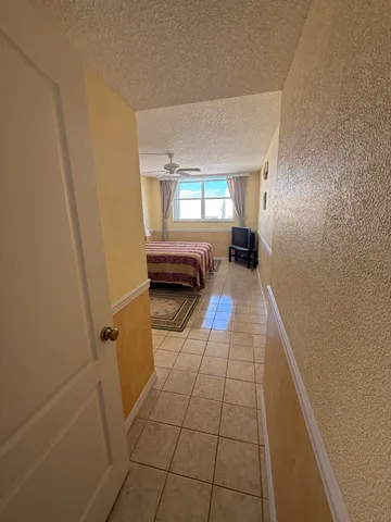 a hallway with a window and a couch