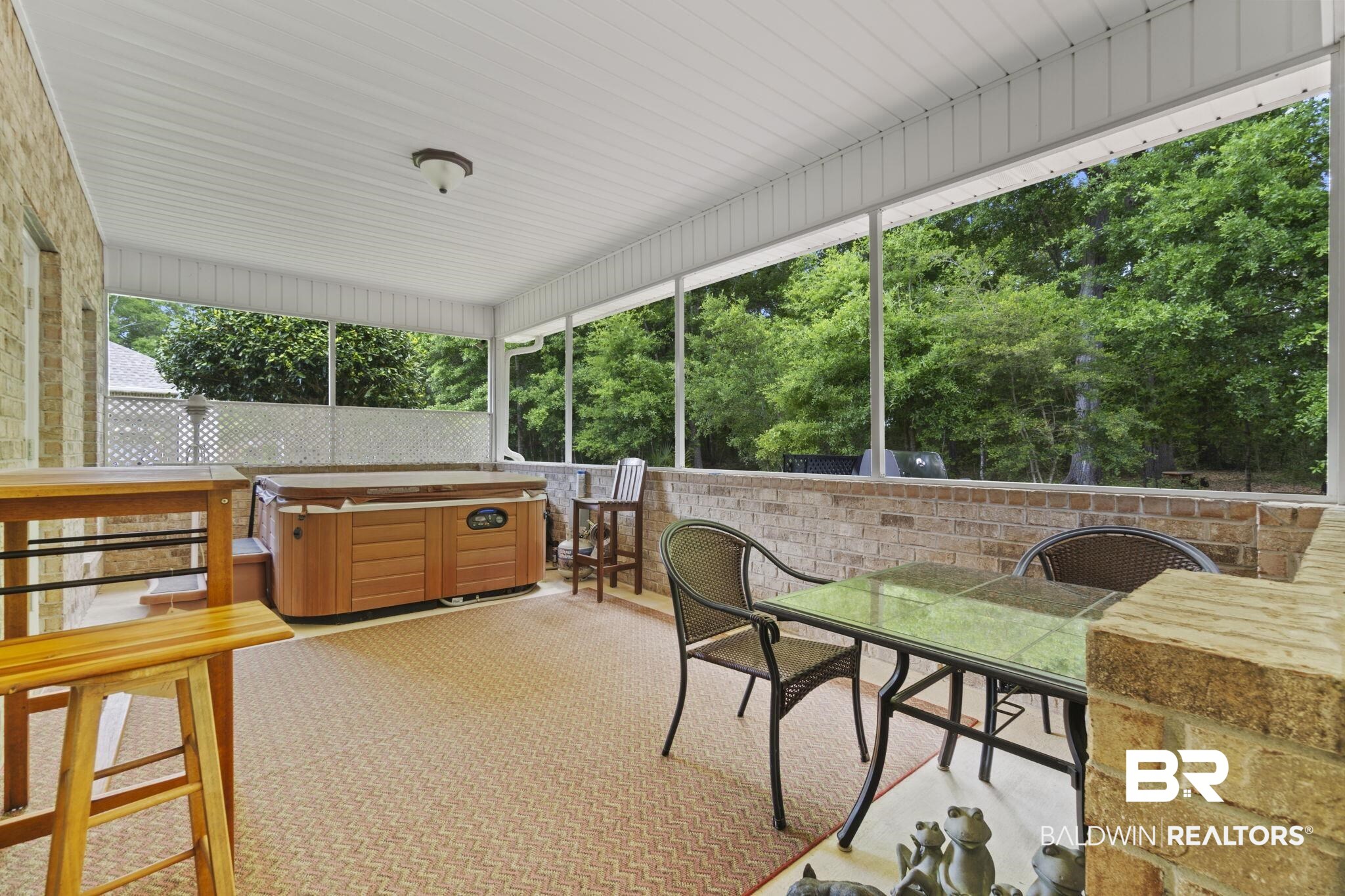8664 Foxtail Loop Pensacola, FL 32526 - Photo 50 of 64 Sunroom featuring a jacuzzi, outdoor dining area, and view of scattered trees
