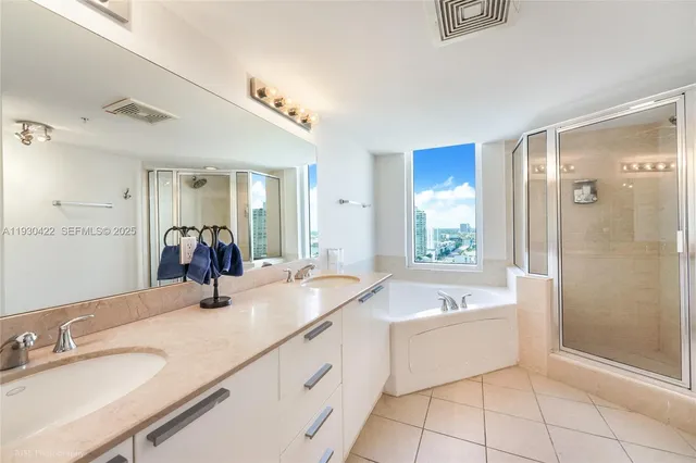 a bathroom with a tub a sink and mirror