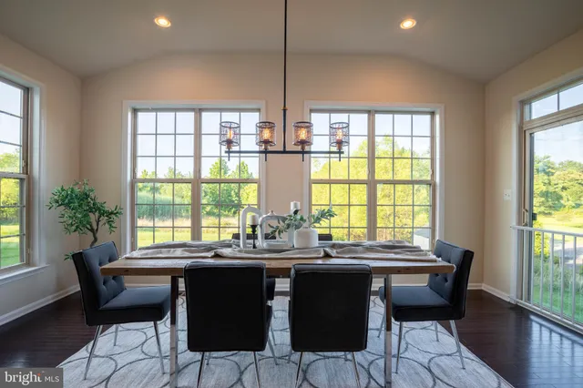 a view of a dining room with furniture and window
