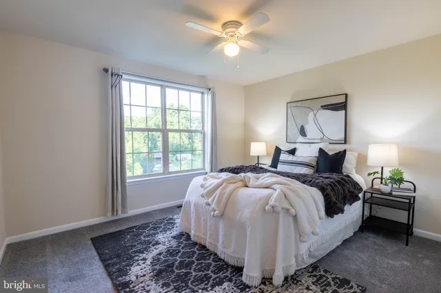 a spacious bedroom with a bed and a window