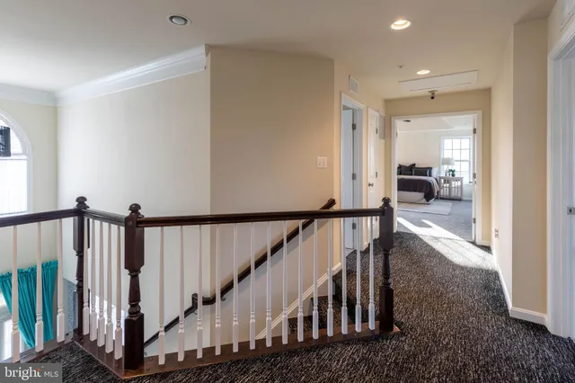 a view of staircase with wooden floor and a rug