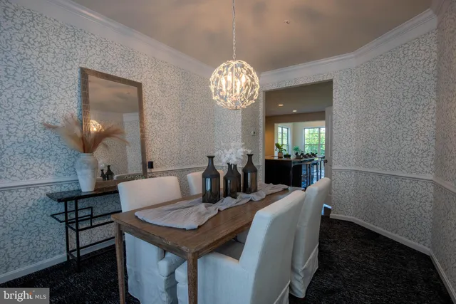 a view of a dining room with furniture and a chandelier