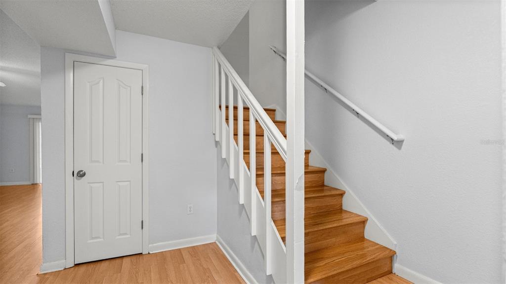 501 Southwest 75th Street, Unit B5 Gainesville, FL 32607 - Photo 12 of 38 a view of staircase with wooden floor and white walls