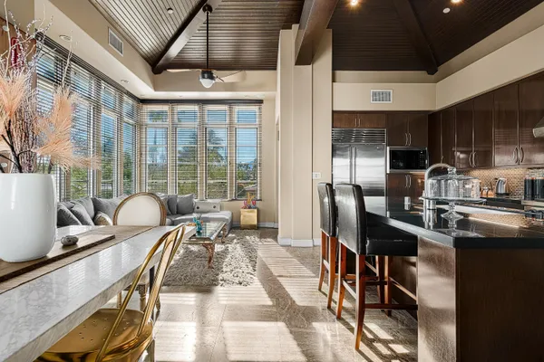 a living room with furniture a flat screen tv and a large window