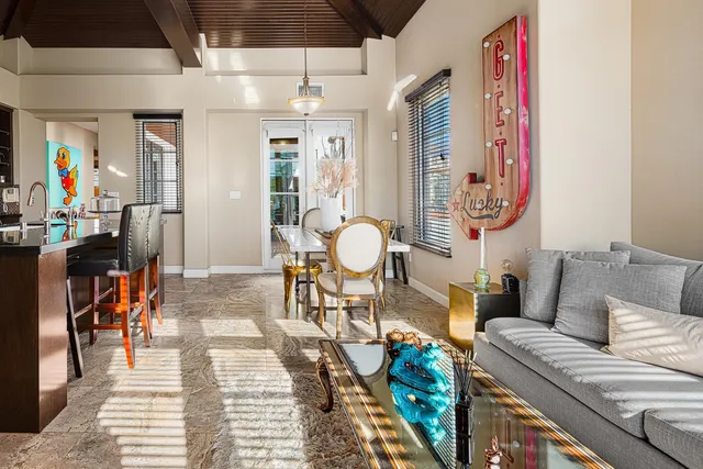 a living room with furniture and a chandelier
