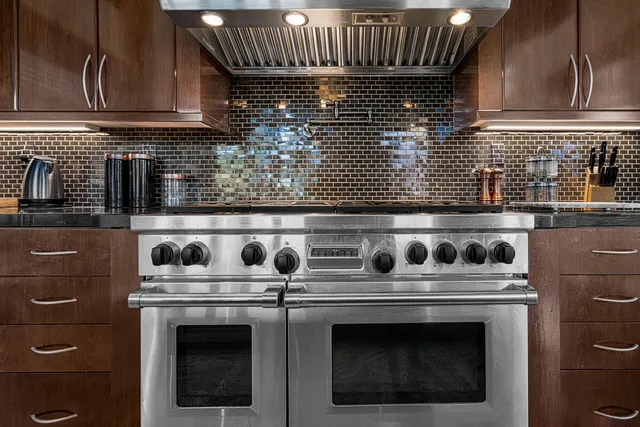 a close view of a stove top oven sitting inside of a kitchen