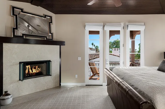 a view of an empty room with a fireplace and a window