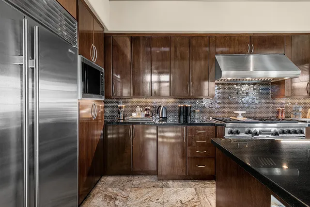 a kitchen with a sink stove and refrigerator