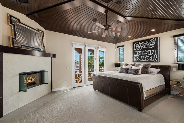 a spacious bedroom with a bed and a fireplace