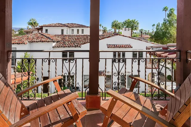 a view of a balcony with furniture