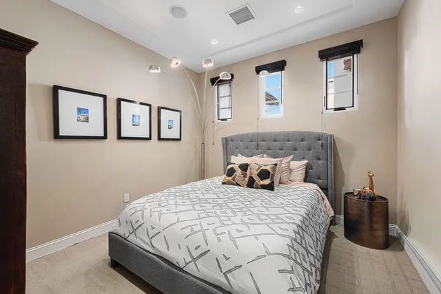 a bedroom with a bed and a wall painting