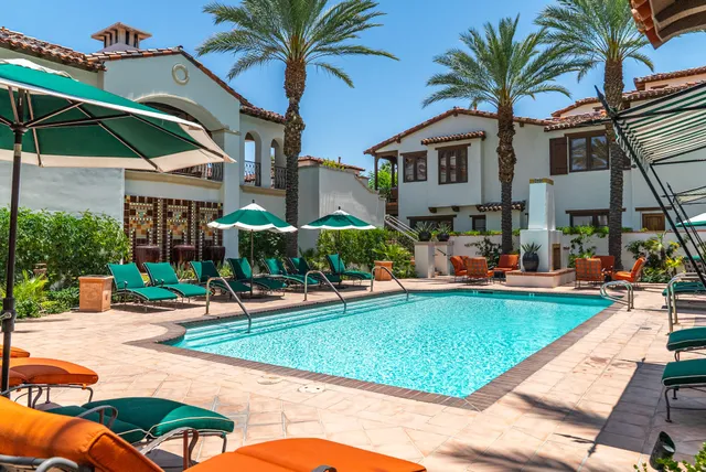 a swimming pool with outdoor seating and yard