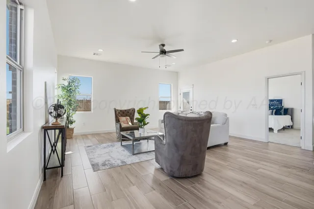 a living room with furniture and a wooden floor