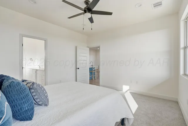 a bedroom with a bed and a ceiling fan