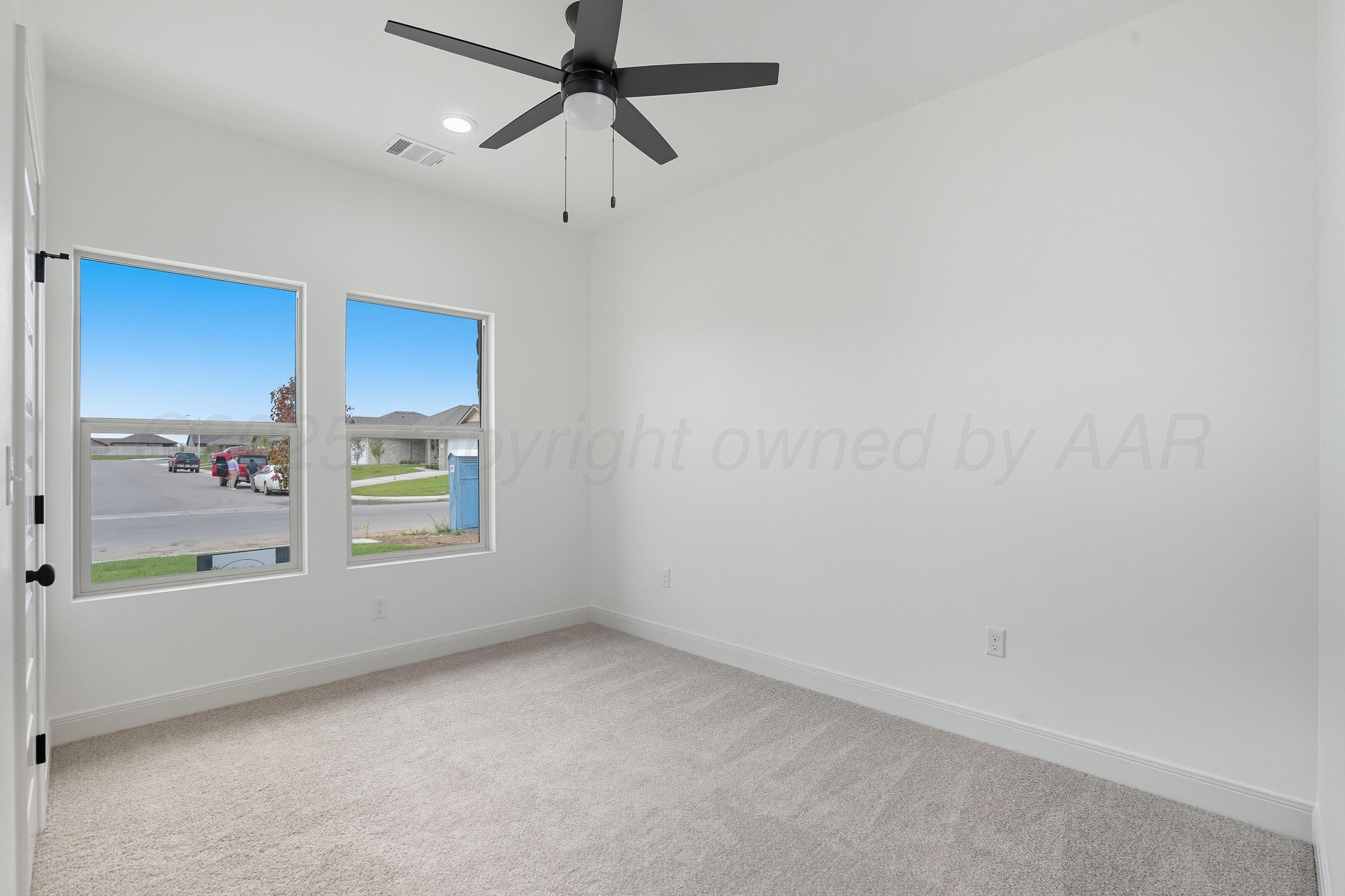 8 Gagestone Drive Canyon, TX 79015 - Photo 5 of 11 an empty room with windows and fan