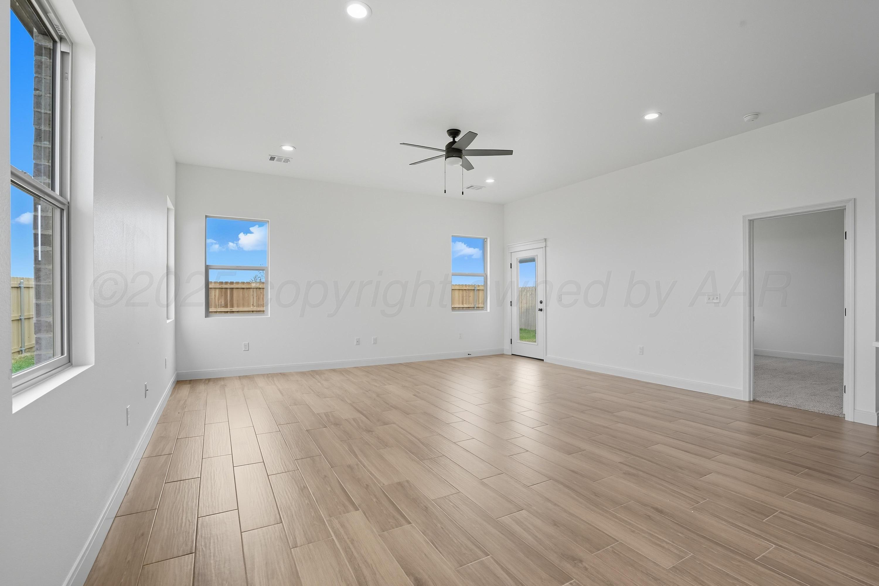 8 Gagestone Drive Canyon, TX 79015 - Photo 7 of 11 an empty room with wooden floor and windows