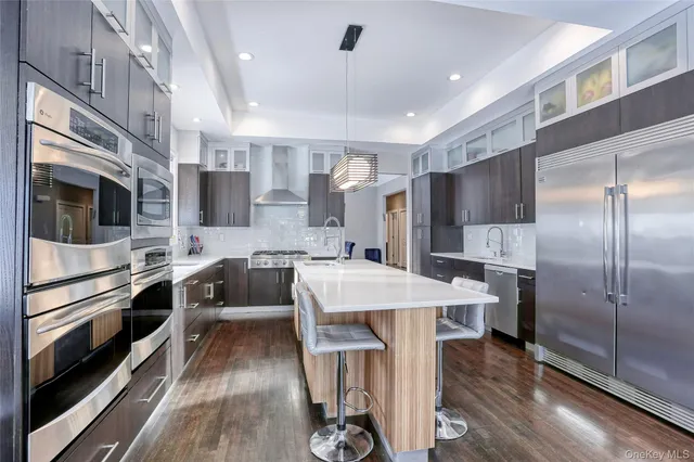 a large kitchen with a large counter top appliances and cabinets