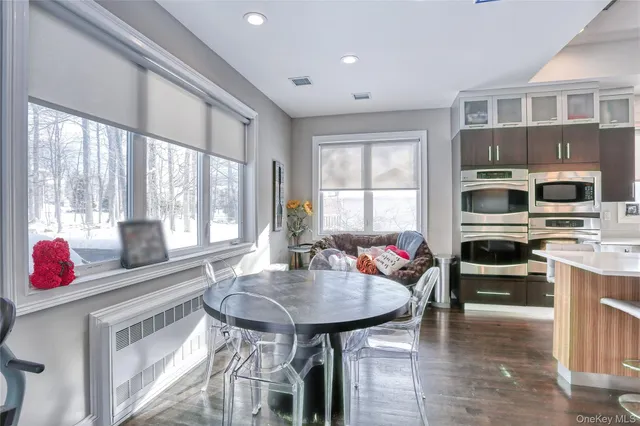 a kitchen with stainless steel appliances kitchen island granite countertop a stove a sink and a refrigerator