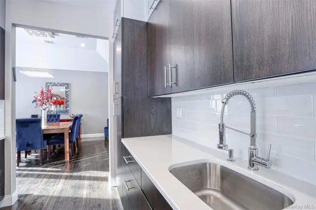 a kitchen with a sink cabinets and dining table