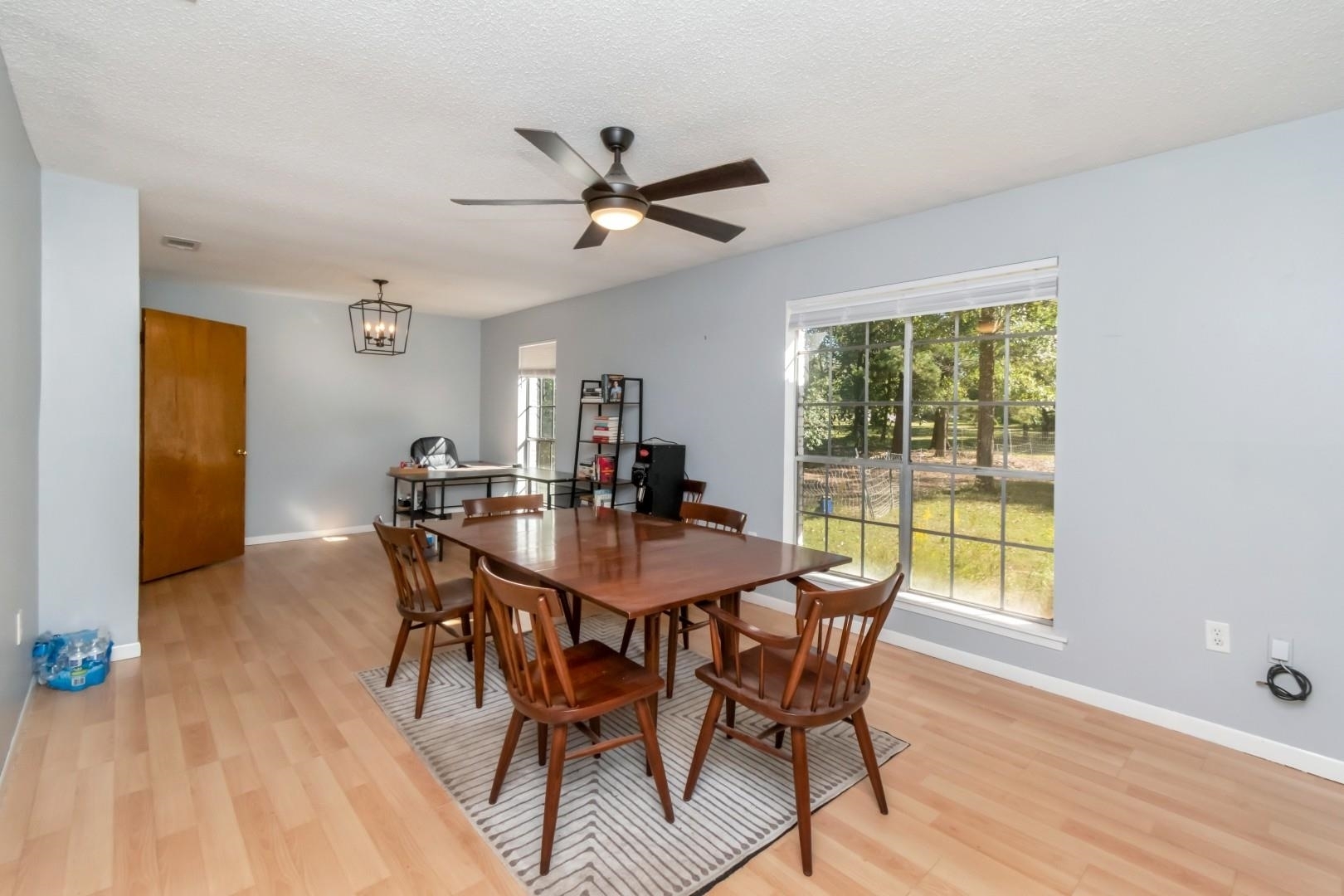 6405 1st Street Wilmer, AL 36587 - Photo 5 of 38 Dining room with light wood-style floors, a textured ceiling, a chandelier, and ceiling fan