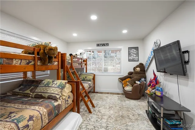 a bed sitting in a spacious bedroom next to a window