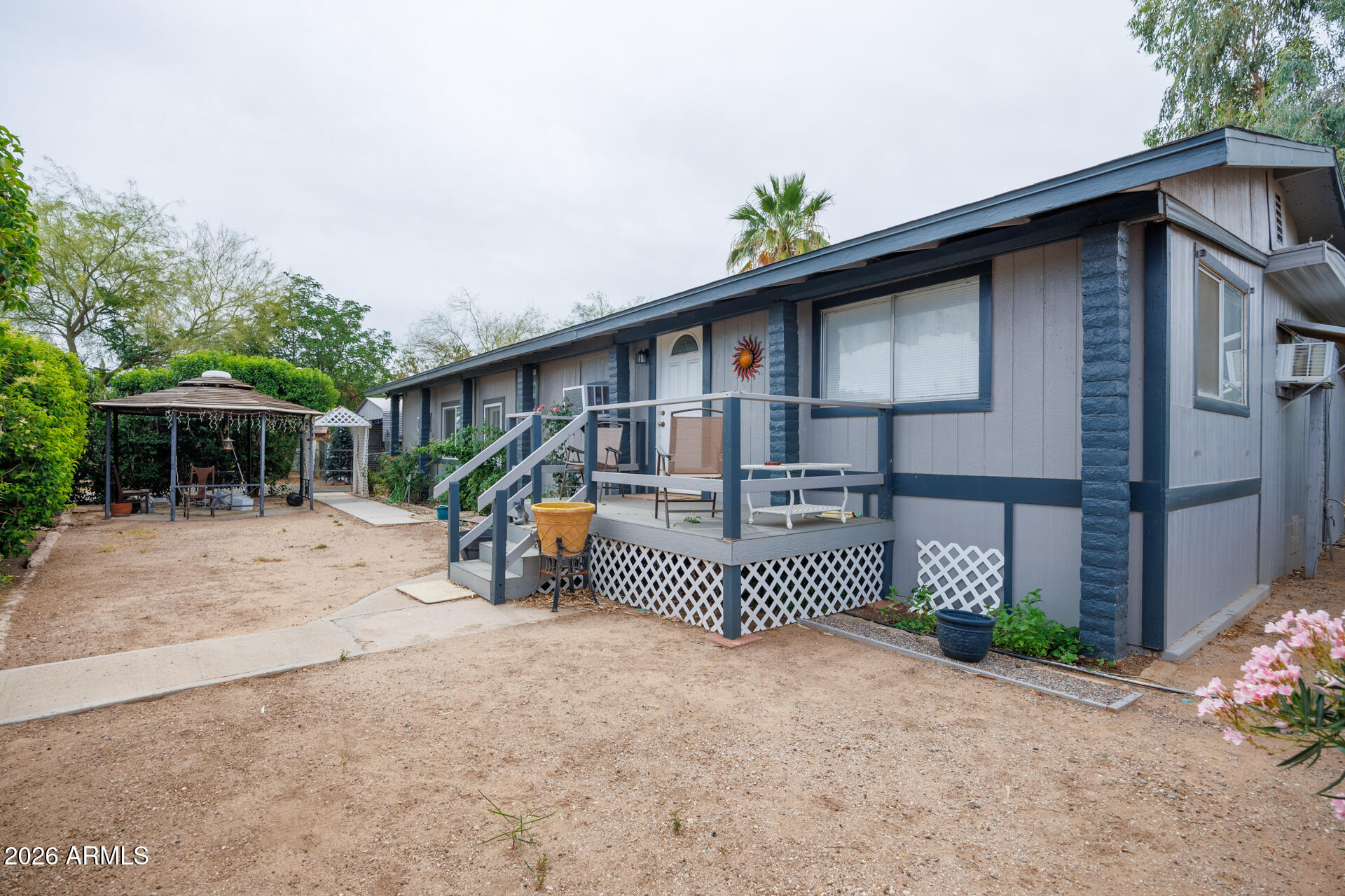 6185 East Monitor Street Picacho, AZ 85141 - Photo 5 of 55 a front view of a house with a garden