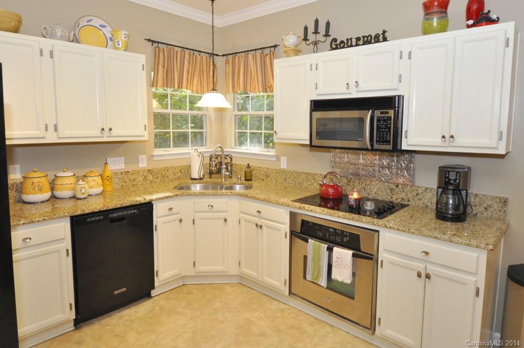 6149 Park Hill Road Charlotte, NC 28277 - Photo 3 of 20 a kitchen with granite countertop white cabinets and white appliances