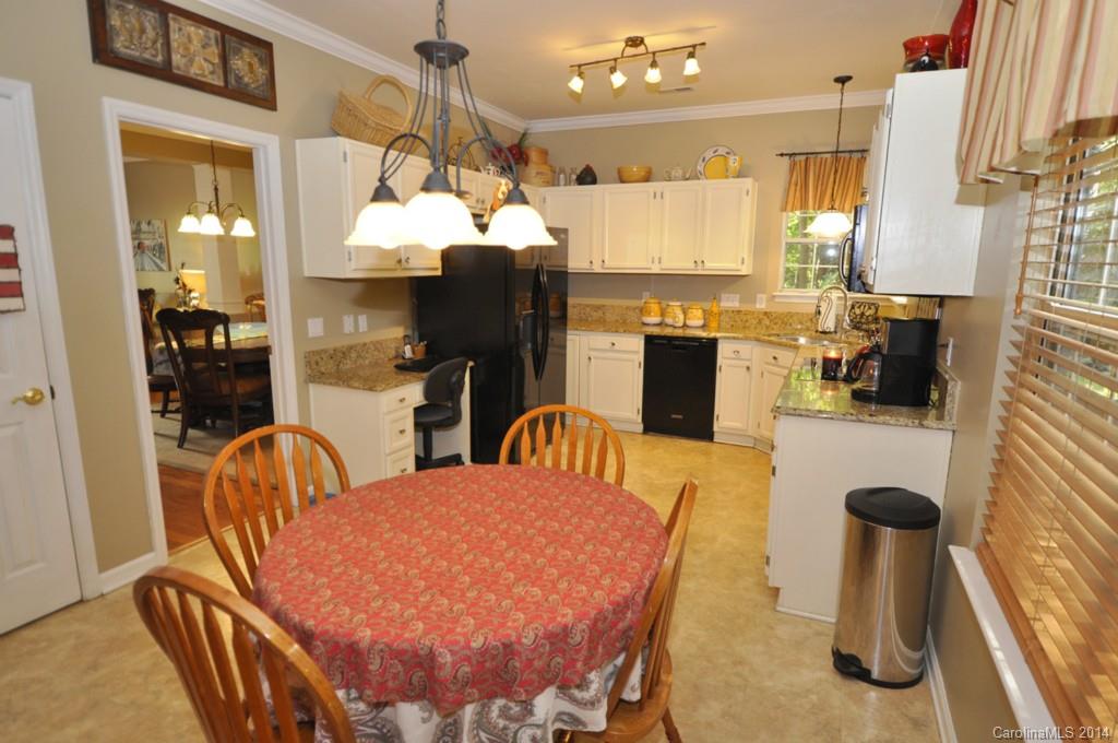 6149 Park Hill Road Charlotte, NC 28277 - Photo 4 of 20 a view of a dining room with furniture and a chandelier