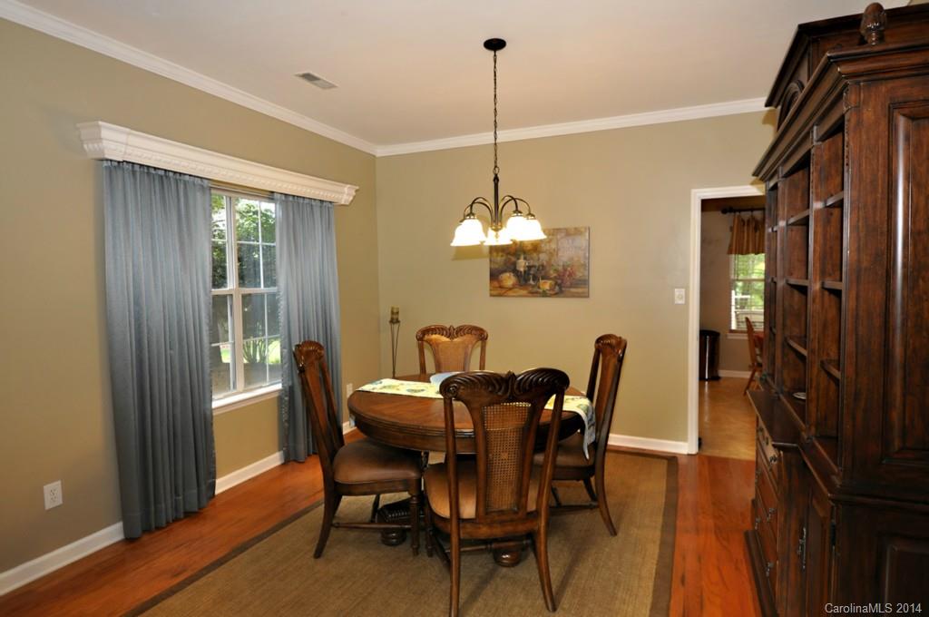 6149 Park Hill Road Charlotte, NC 28277 - Photo 8 of 20 a view of a dining room with furniture a chandelier and wooden floor