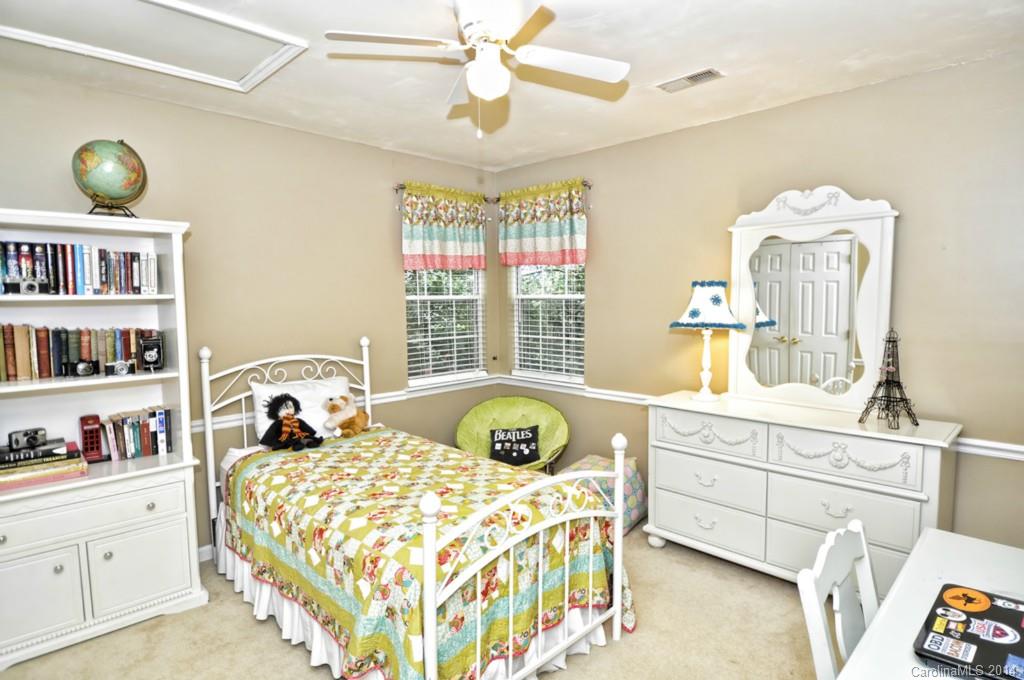 6149 Park Hill Road Charlotte, NC 28277 - Photo 10 of 20 a bedroom with a bed and a cabinets