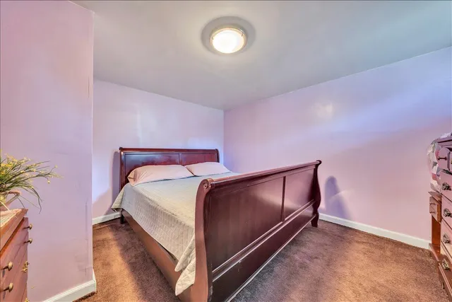 a bedroom with a bed and a potted plant