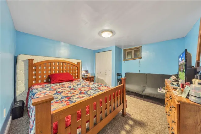 a bedroom with a bed and a couch