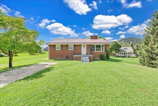 a view of house with a yard