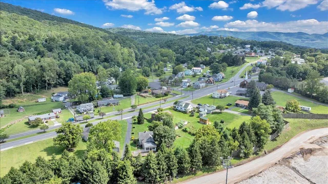 an aerial view of a houses with a yard