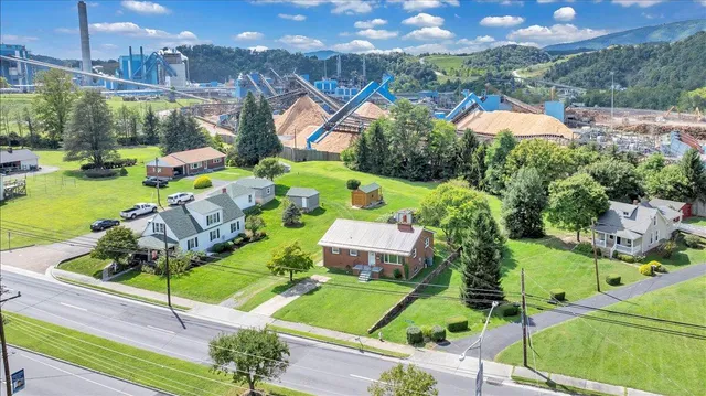 an aerial view of a house with garden space and street view