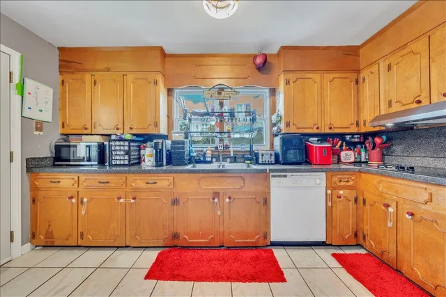 a kitchen with stainless steel appliances granite countertop a refrigerator a stove and a microwave