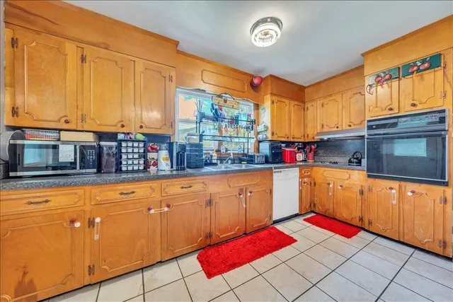 a kitchen with stainless steel appliances granite countertop a sink and cabinets