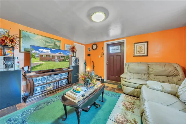 a living room with furniture and a flat screen tv