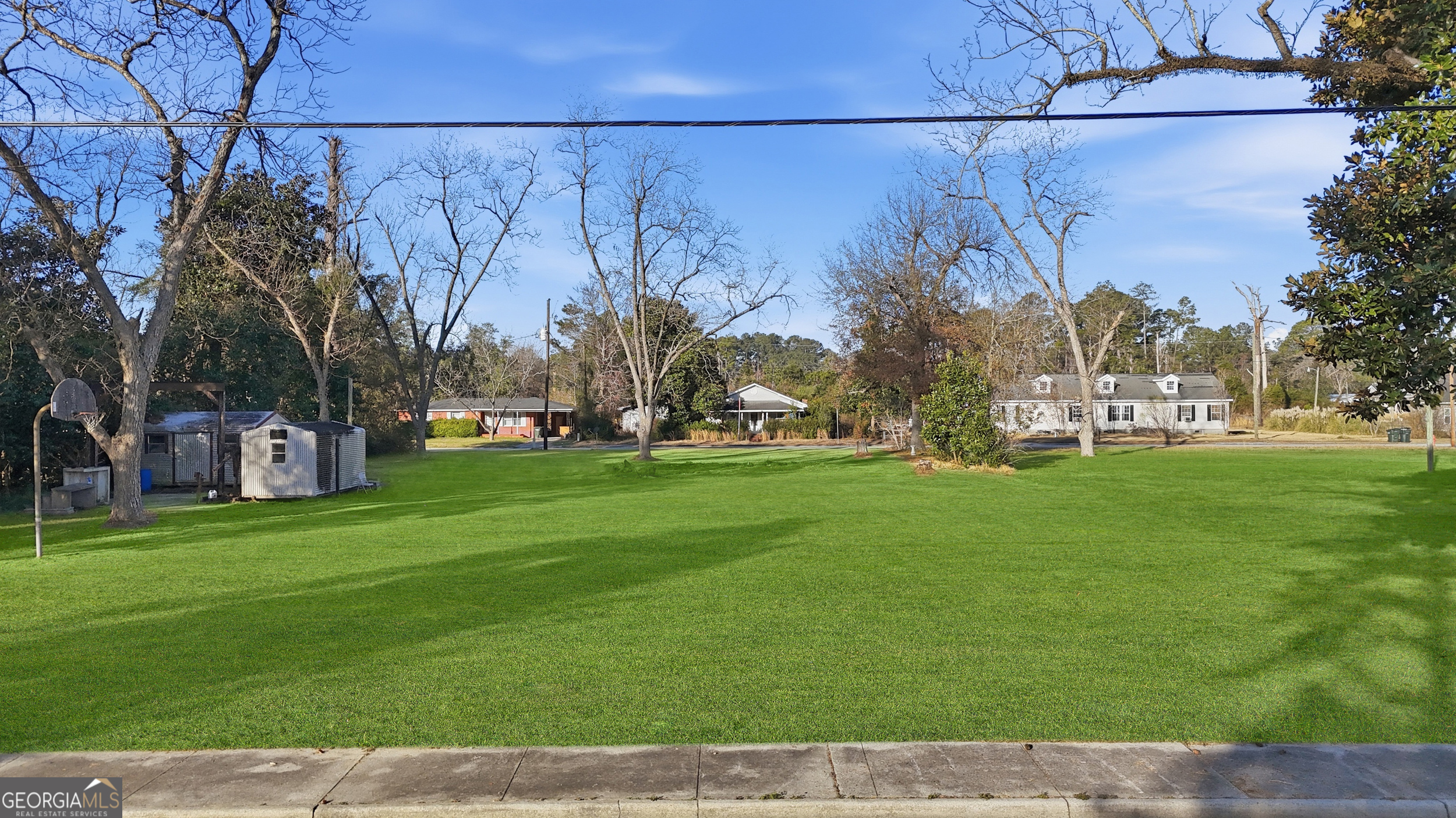 273 South Main Street Pembroke, GA 31321 - Photo 3 of 22 a view of a street with houses