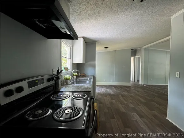 a kitchen with a stove and a refrigerator