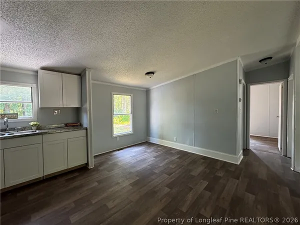a kitchen with granite countertop a stove and a refrigerator