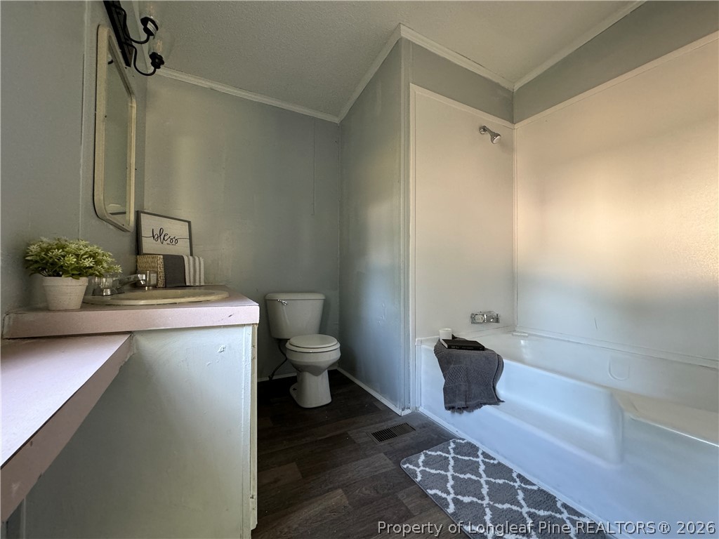 511 Inverary Drive Raeford, NC 28376 - Photo 20 of 32 a bathroom with a sink toilet and shower