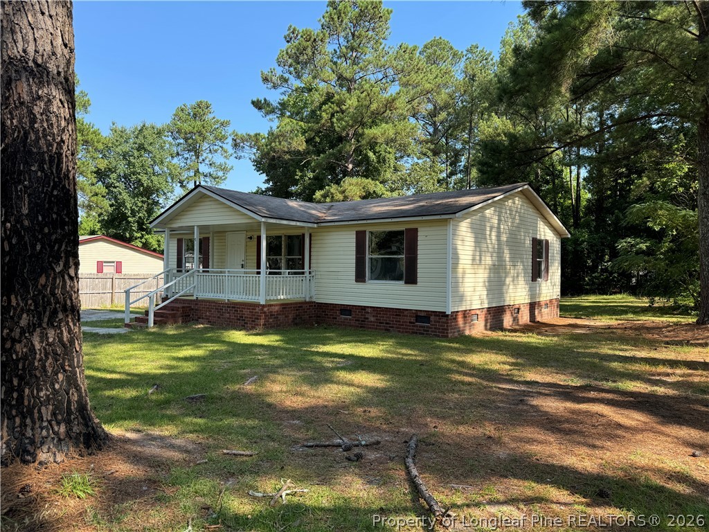 511 Inverary Drive Raeford, NC 28376 - Photo 2 of 32 a view of a house with a yard patio and tree