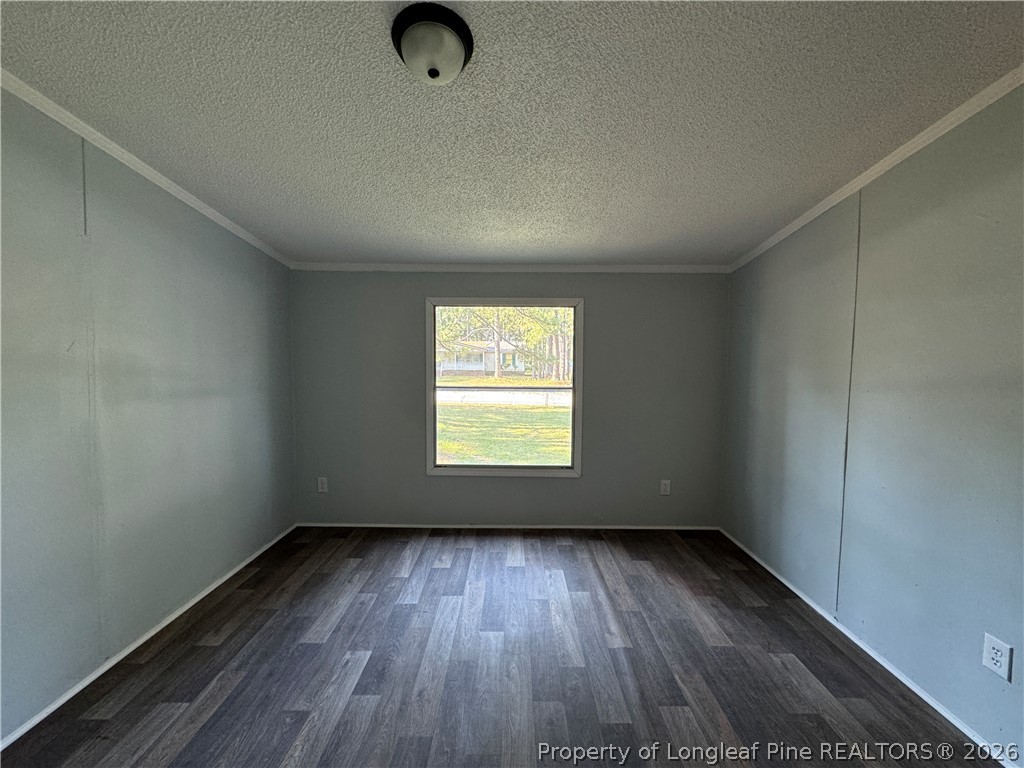 511 Inverary Drive Raeford, NC 28376 - Photo 21 of 32 an empty room with wooden floor and windows