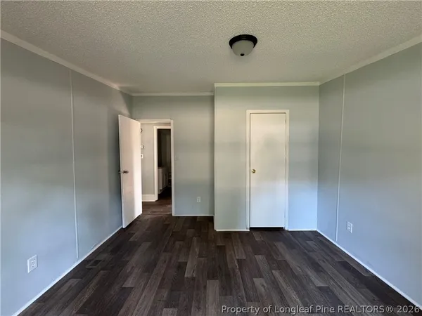 a view of a room with wooden floor